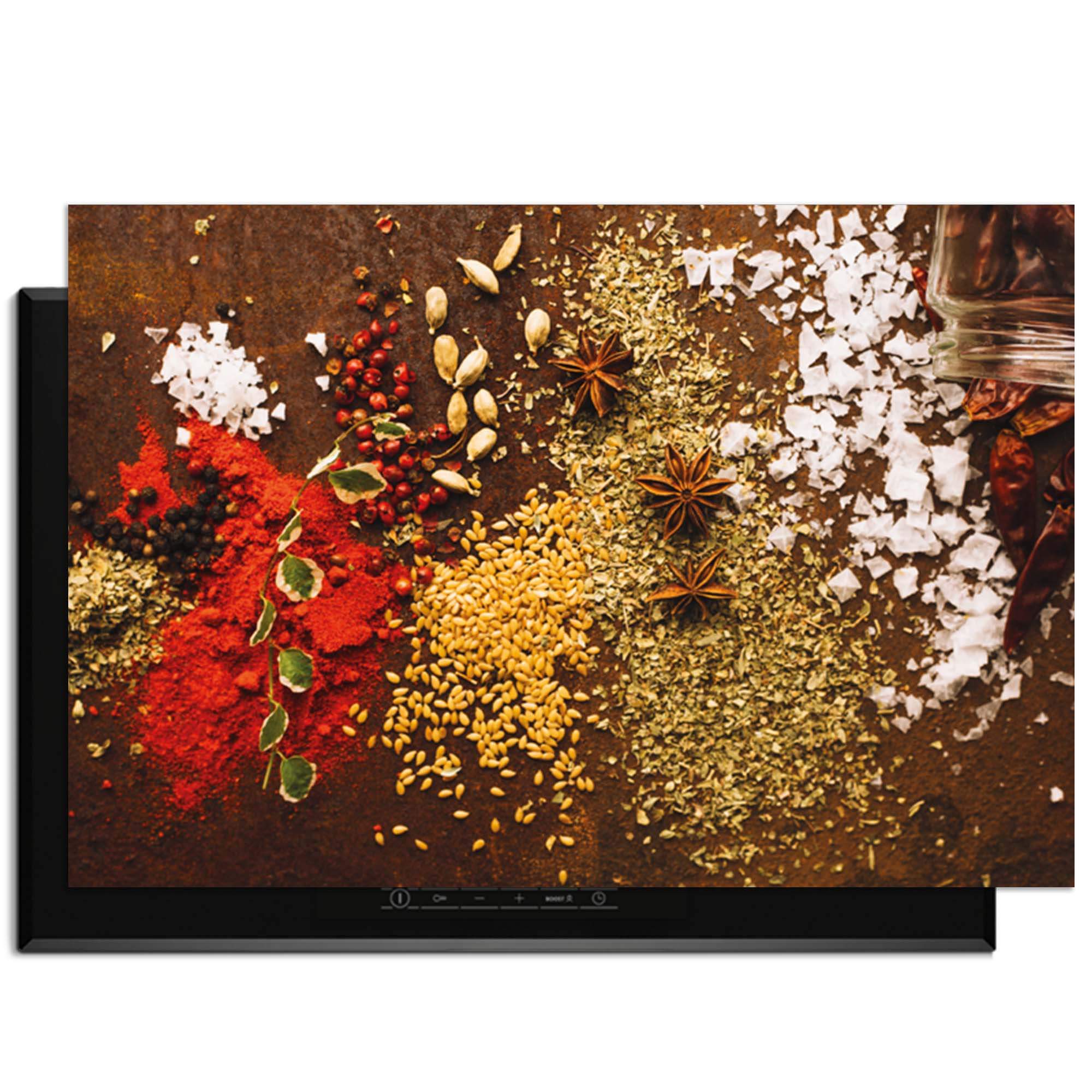 Spice Symphony - Herdabdeckplatte mit bunten Gewürzen auf einem Induktionskochfeld.