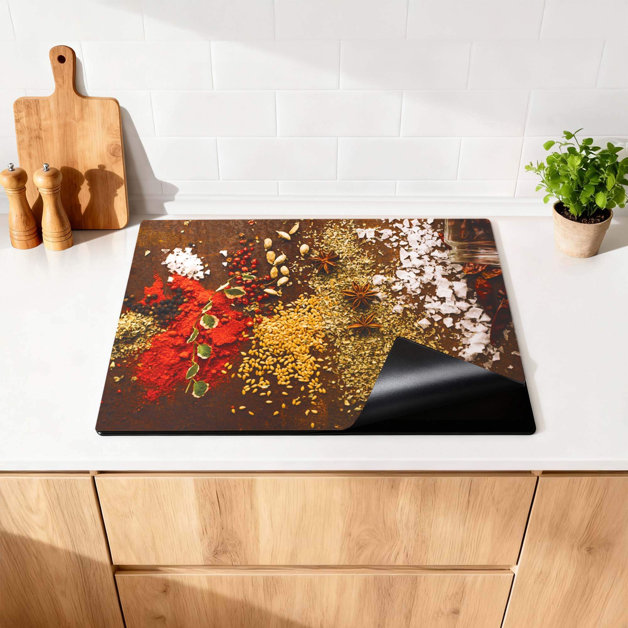 Spice Symphony - Herdabdeckplatte mit bunten Gewürzen auf einer Küchenplatte.