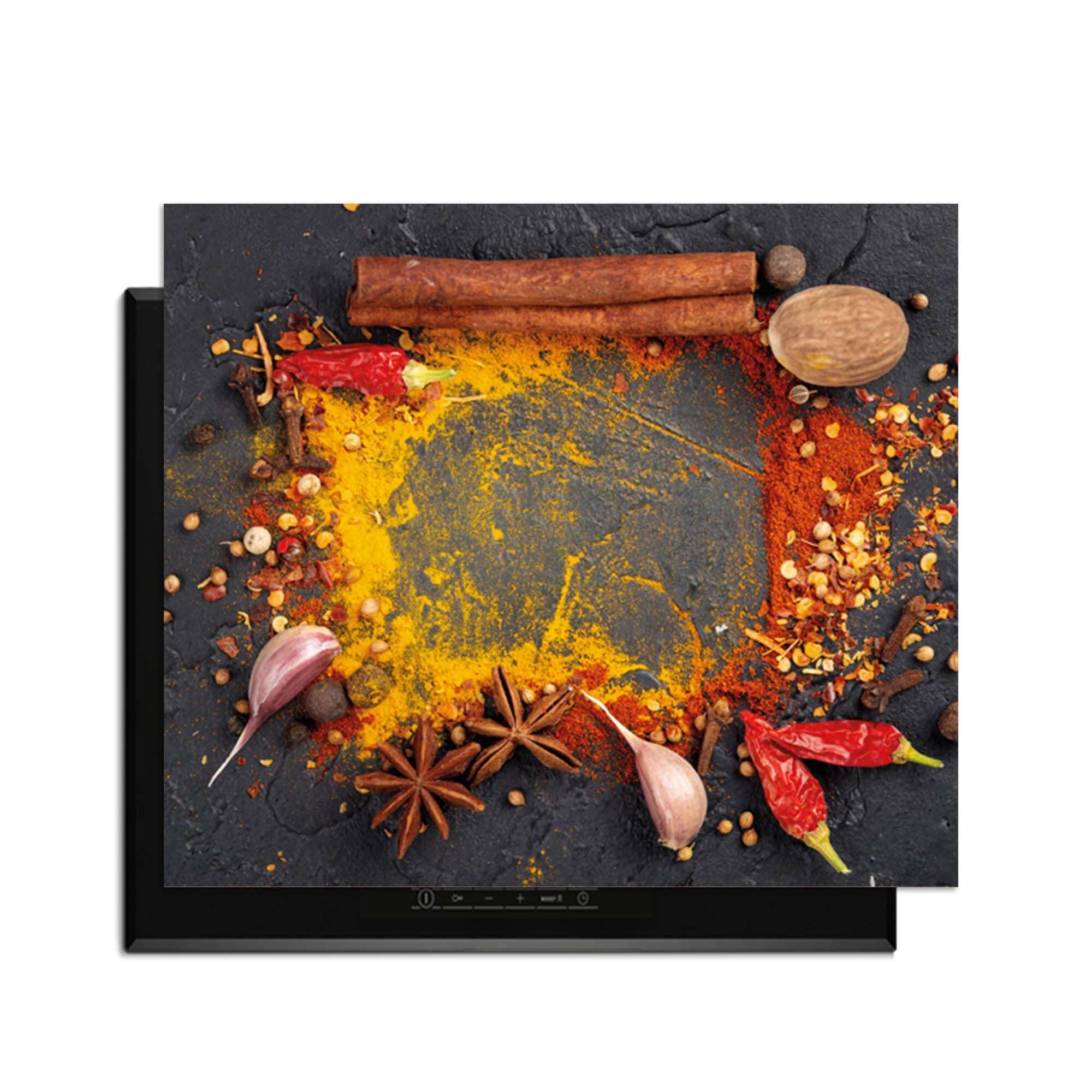 Eastern Spice Mix - Herdabdeckplatte mit bunten Gewürzen auf dem Induktionskochfeld.