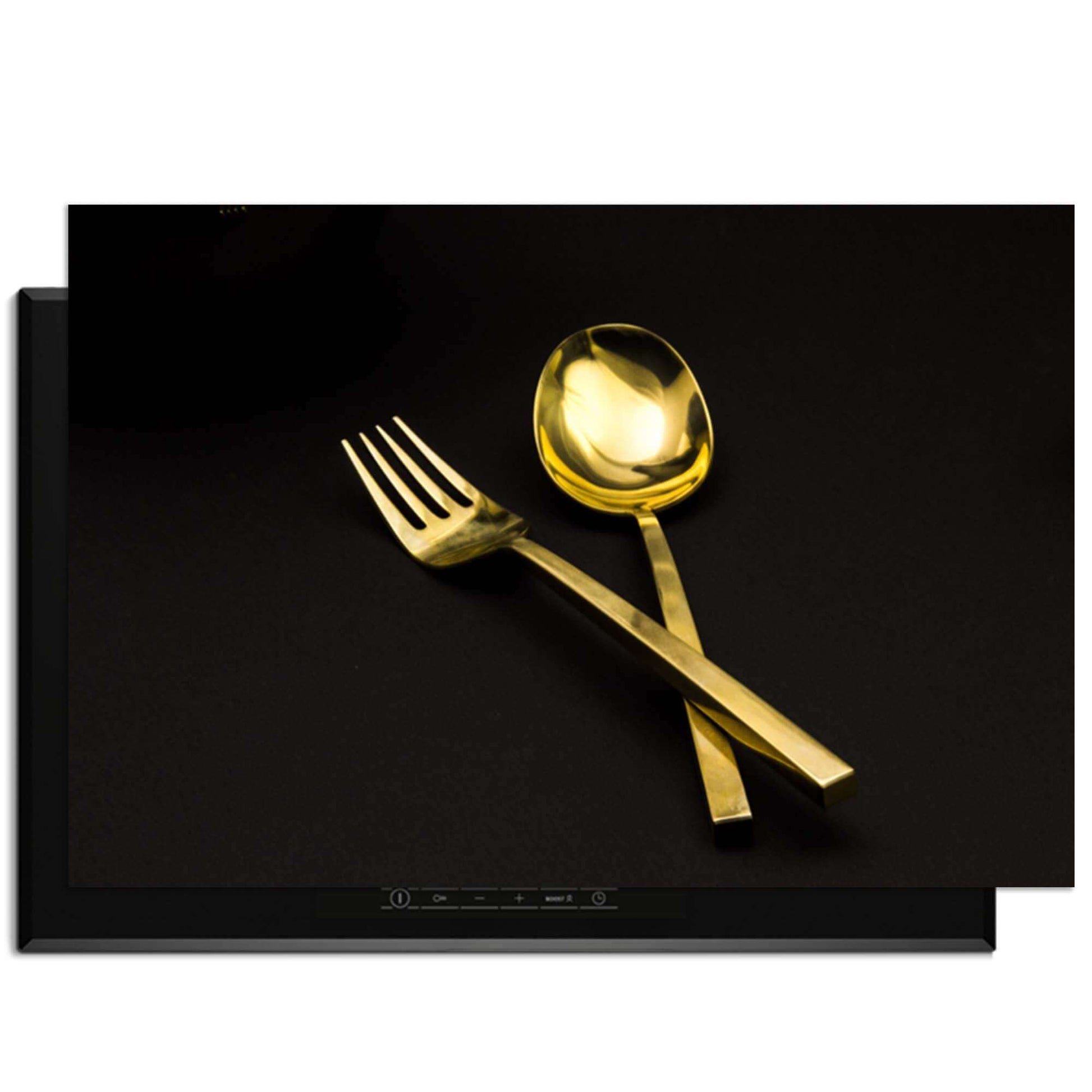 Dining Deluxe - Herdabdeckplatte mit goldenem Besteck auf schwarzem Hintergrund.